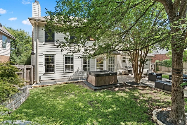7016 Bending Oak Rd, Austin, TX 78749 - back of house with a hot tub, a patio, and a chimney