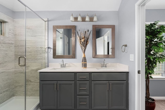 143 Dogvane Cir, Kyle, TX 78640 - bathroom with a shower stall, double vanity, and baseboards