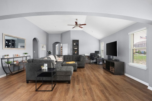 143 Dogvane Cir, Kyle, TX 78640 - living area with arched walkways, lofted ceiling, a ceiling fan, wood finished floors, and baseboards