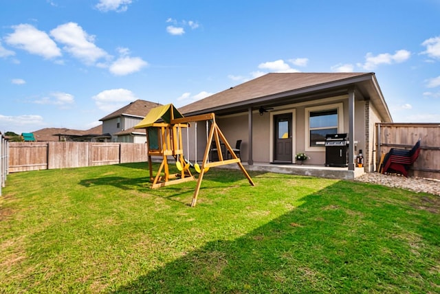 143 Dogvane Cir, Kyle, TX 78640 - back of house featuring a playground, stucco siding, a patio, and a ceiling fan