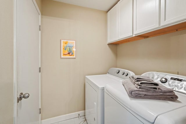 3701 Clendenin Ct, Austin, TX 78732 - laundry area with cabinet space, washing machine and clothes dryer, baseboards, and light marble finish floors