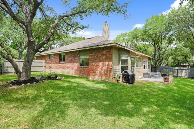 3701 Clendenin Ct, Austin, TX 78732 - rear view of house with a chimney, a patio, brick siding, and an outdoor hangout area