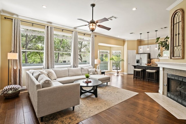 3701 Clendenin Ct, Austin, TX 78732 - living room featuring crown molding, a ceiling fan, dark wood-type flooring, recessed lighting, and a fireplace