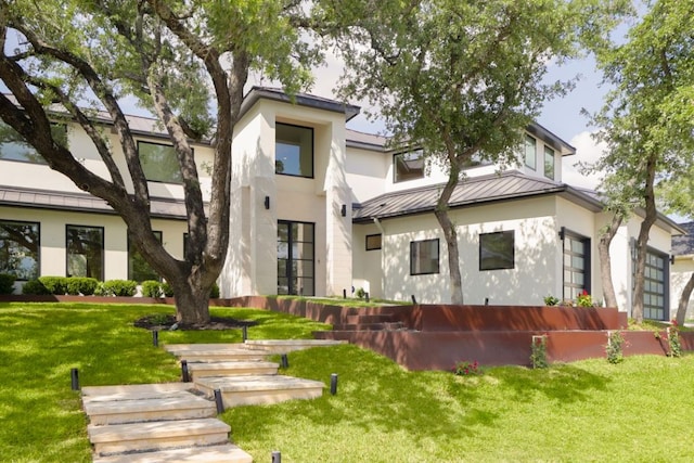 1800 Bay Hill Dr, Austin, TX 78746 - rear view of property with a standing seam roof, stucco siding, metal roof, and a lawn