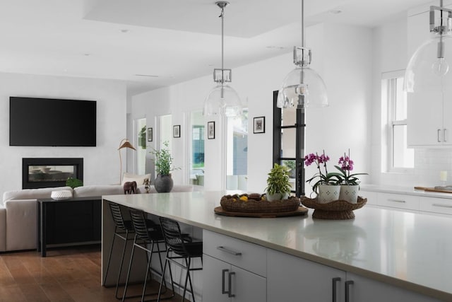 1800 Bay Hill Dr, Austin, TX 78746 - kitchen with light countertops, open floor plan, a breakfast bar, and white cabinetry