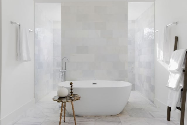 1800 Bay Hill Dr, Austin, TX 78746 - bathroom with a soaking tub, baseboards, and marble finish floors