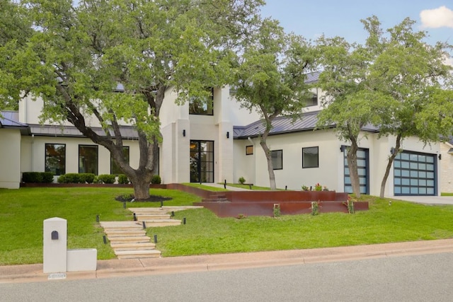 1800 Bay Hill Dr, Austin, TX 78746 - contemporary home featuring a standing seam roof, stucco siding, metal roof, and a front yard