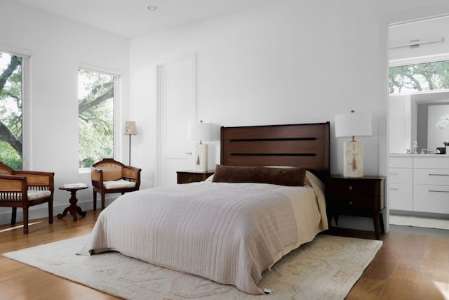 1800 Bay Hill Dr, Austin, TX 78746 - bedroom with multiple windows, wood finished floors, and ensuite bathroom