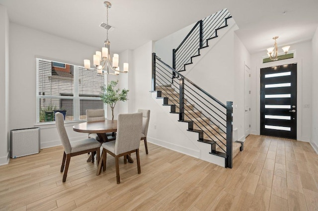 3109 Sorin St, Austin, TX 78723 - dining area with a chandelier, light wood-style flooring, stairway, and baseboards