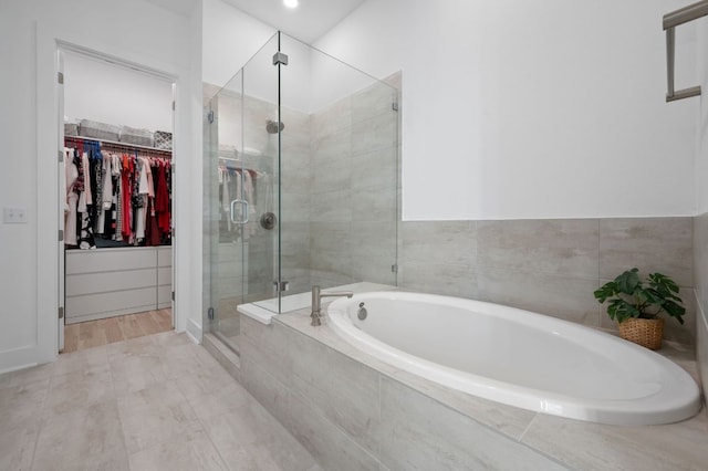 3109 Sorin St, Austin, TX 78723 - full bath with a walk in closet, a shower stall, and a garden tub