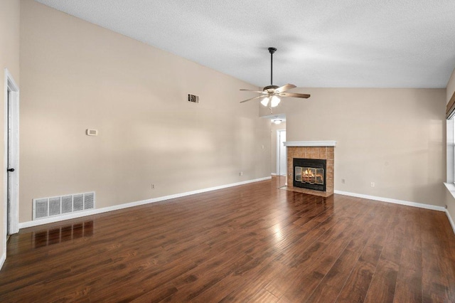 13018 Garfield Ln, Austin, TX 78727 - unfurnished living room featuring vaulted ceiling, wood finished floors, a ceiling fan, a fireplace, and baseboards
