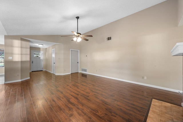 13018 Garfield Ln, Austin, TX 78727 - unfurnished living room with wood finished floors, a ceiling fan, baseboards, and vaulted ceiling