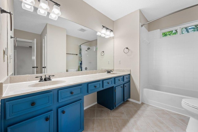 13018 Garfield Ln, Austin, TX 78727 - bathroom featuring toilet, double vanity, tile patterned floors, and shower / bathtub combination