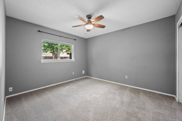 13018 Garfield Ln, Austin, TX 78727 - empty room with ceiling fan, carpet flooring, a textured ceiling, and baseboards