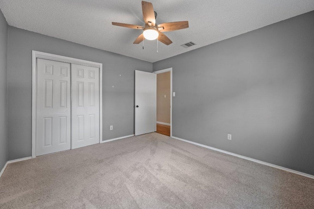 13018 Garfield Ln, Austin, TX 78727 - unfurnished bedroom with carpet, a closet, baseboards, ceiling fan, and a textured ceiling