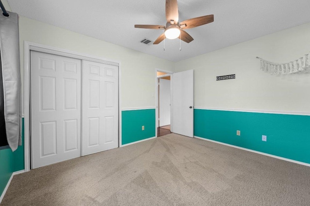13018 Garfield Ln, Austin, TX 78727 - unfurnished bedroom with carpet, a closet, baseboards, and a ceiling fan