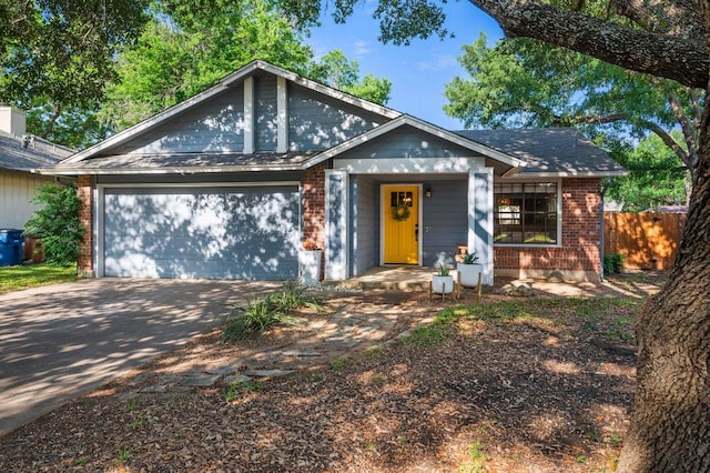 13018 Garfield Ln, Austin, TX 78727 - view of front facade featuring brick siding, a garage, and concrete driveway