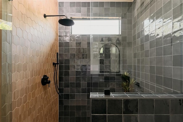 bathroom with tiled shower