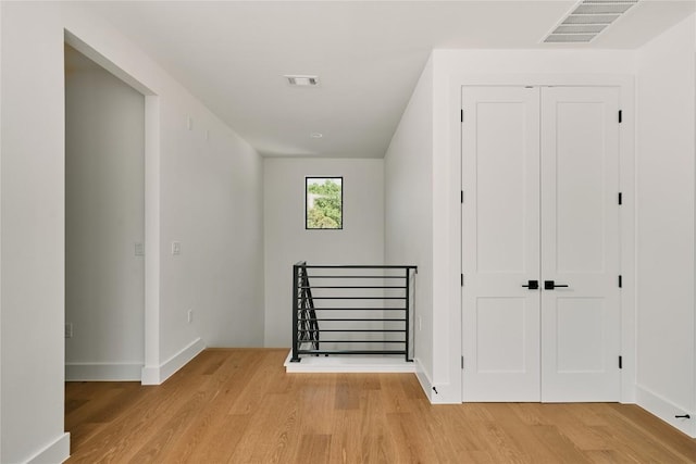 interior space featuring light wood-type flooring and baseboards