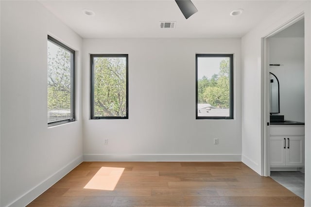 5805 Mojave Dr, Austin, TX 78745 - unfurnished room featuring healthy amount of natural light, light wood finished floors, baseboards, and recessed lighting