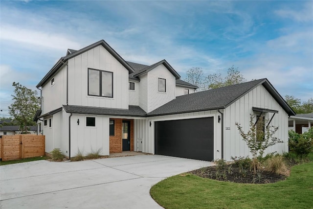 modern farmhouse with board and batten siding, fence, a shingled roof, and an attached garage