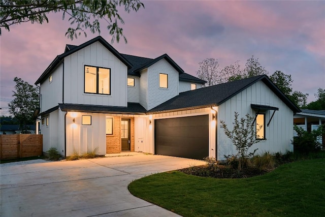 modern farmhouse style home featuring board and batten siding, driveway, a garage, and roof with shingles
