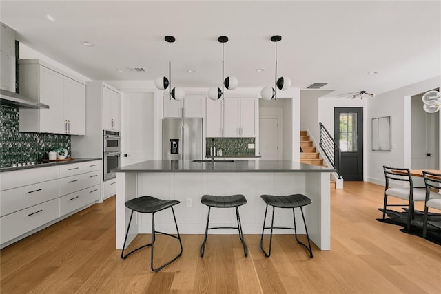 5805 Mojave Dr, Austin, TX 78745 - kitchen with appliances with stainless steel finishes, dark countertops, a sink, tasteful backsplash, and recessed lighting