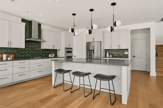 5805 Mojave Dr, Austin, TX 78745 - kitchen with wall chimney exhaust hood, stainless steel appliances, dark countertops, a kitchen bar, and backsplash
