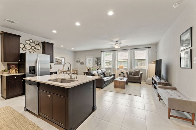 537 Appalachian Trl, Leander, TX 78641 - kitchen with stainless steel appliances, a sink, open floor plan, dark brown cabinetry, and recessed lighting