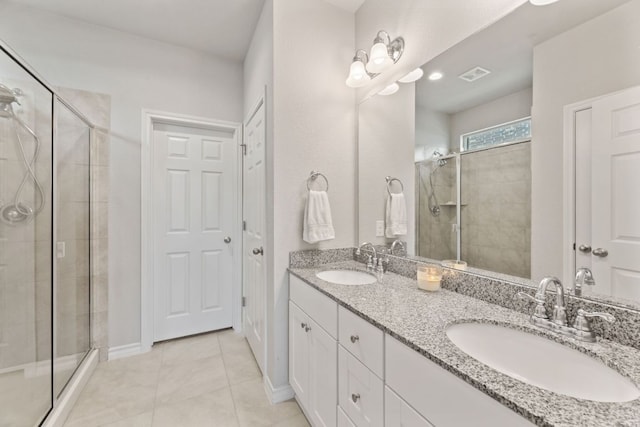 537 Appalachian Trl, Leander, TX 78641 - bathroom with a stall shower, double vanity, tile patterned floors, and baseboards