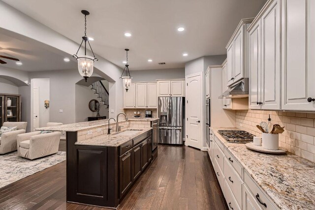 2516 Arion Cir, Austin, TX 78730 - kitchen featuring appliances with stainless steel finishes, a sink, open floor plan, dark wood-type flooring, and recessed lighting