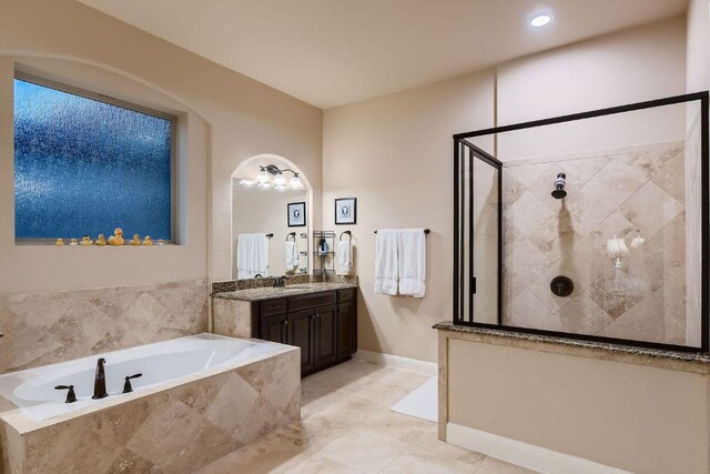 2516 Arion Cir, Austin, TX 78730 - bathroom featuring a stall shower, a garden tub, vanity, baseboards, and recessed lighting