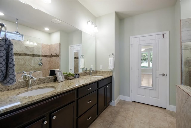 111 Bear Creek Ln, Georgetown, TX 78633 - bathroom featuring double vanity, a walk in shower, tile patterned flooring, and baseboards