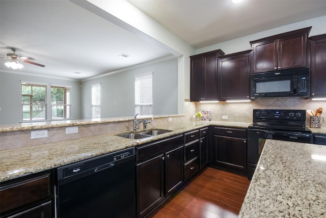 111 Bear Creek Ln, Georgetown, TX 78633 - kitchen with black appliances, a sink, light stone countertops, dark wood-type flooring, and ornamental molding