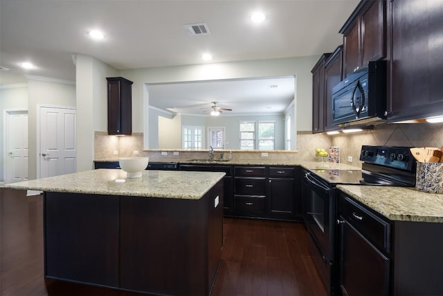 111 Bear Creek Ln, Georgetown, TX 78633 - kitchen featuring black appliances, dark wood-type flooring, ornamental molding, a center island, and a sink