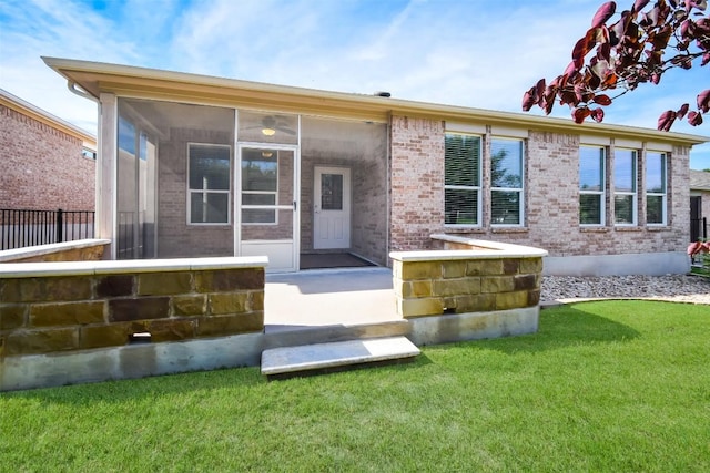 111 Bear Creek Ln, Georgetown, TX 78633 - back of property featuring a sunroom, brick siding, and a lawn