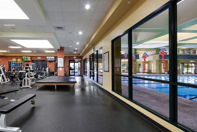 111 Bear Creek Ln, Georgetown, TX 78633 - gym with a paneled ceiling and healthy amount of natural light