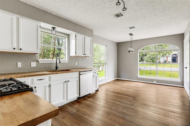 kitchen featuring dishwasher, a sink, dark wood-style flooring, white cabinetry, and wood counters