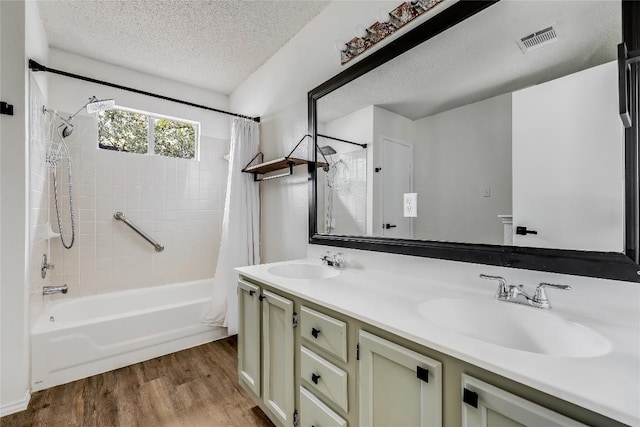 3109 Blazing Star Trl, Cedar Park, TX 78613 - full bathroom featuring shower / bathtub combination with curtain, wood finished floors, double vanity, and a textured ceiling