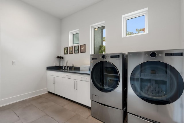 908 Cypress Grove Dr, Austin, TX 78732 - laundry room with washer and dryer, cabinet space, and light tile patterned floors