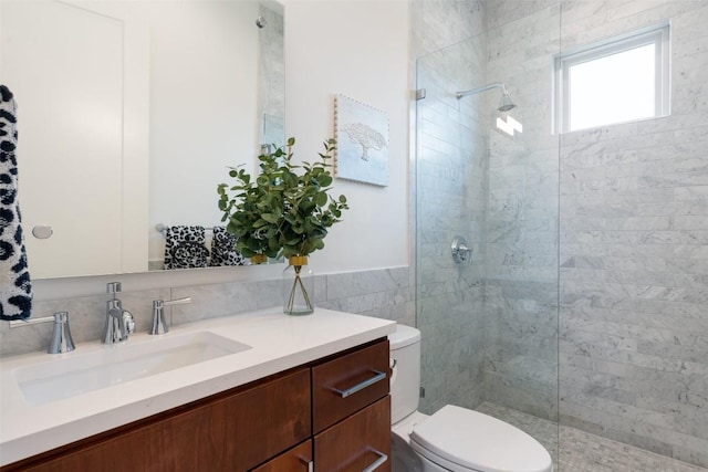 full bath with a walk in shower, tile walls, toilet, and vanity