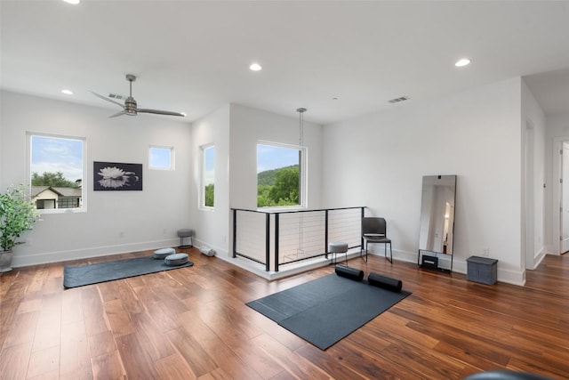exercise room featuring recessed lighting, ceiling fan, wood finished floors, and baseboards