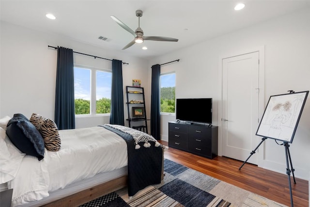 bedroom featuring wood finished floors, recessed lighting, ceiling fan, and baseboards
