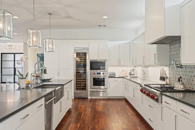 kitchen featuring a sink, appliances with stainless steel finishes, wine cooler, a warming drawer, and custom range hood
