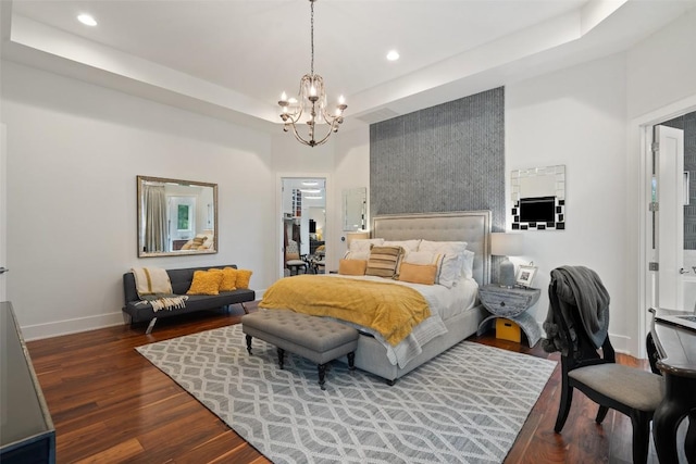 bedroom with baseboards, a chandelier, dark wood-type flooring, recessed lighting, and a tray ceiling
