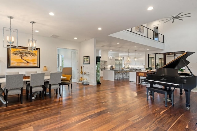 dining area with a chandelier, dark wood-style floors, recessed lighting, and baseboards
