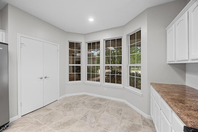 258 Whispering Wind Dr, Georgetown, TX 78633 - unfurnished dining area featuring recessed lighting and baseboards