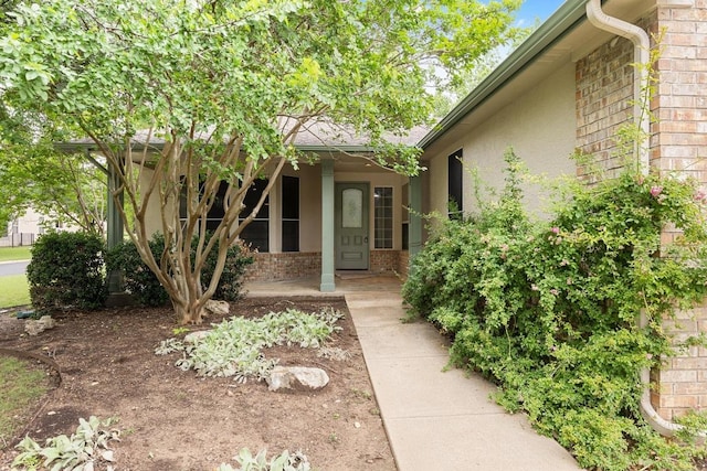 258 Whispering Wind Dr, Georgetown, TX 78633 - entrance to property with brick siding, a porch, and stucco siding