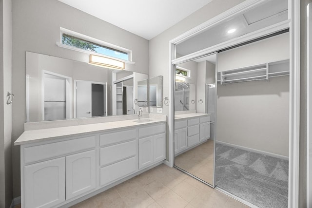 258 Whispering Wind Dr, Georgetown, TX 78633 - bathroom with vanity, a walk in closet, and tile patterned flooring