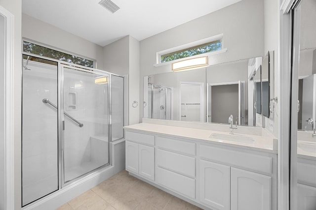 258 Whispering Wind Dr, Georgetown, TX 78633 - full bathroom featuring double vanity, a shower stall, and tile patterned floors